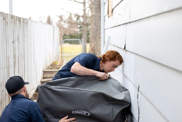 Two employee is preparing to setup AC system 