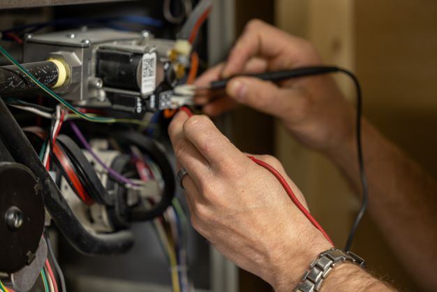 A technician performing HVAC Service 