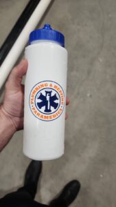 A white water bottle with a blue cap having company logo.